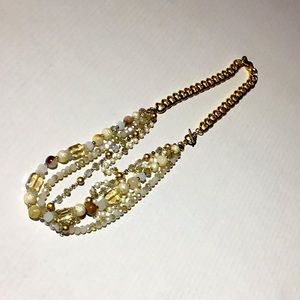 Gold toned chain with cream beads necklace.